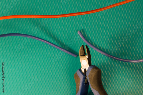 Cutting red or blue wire by wire cutters. Safety precautions, bomb neutralization photo