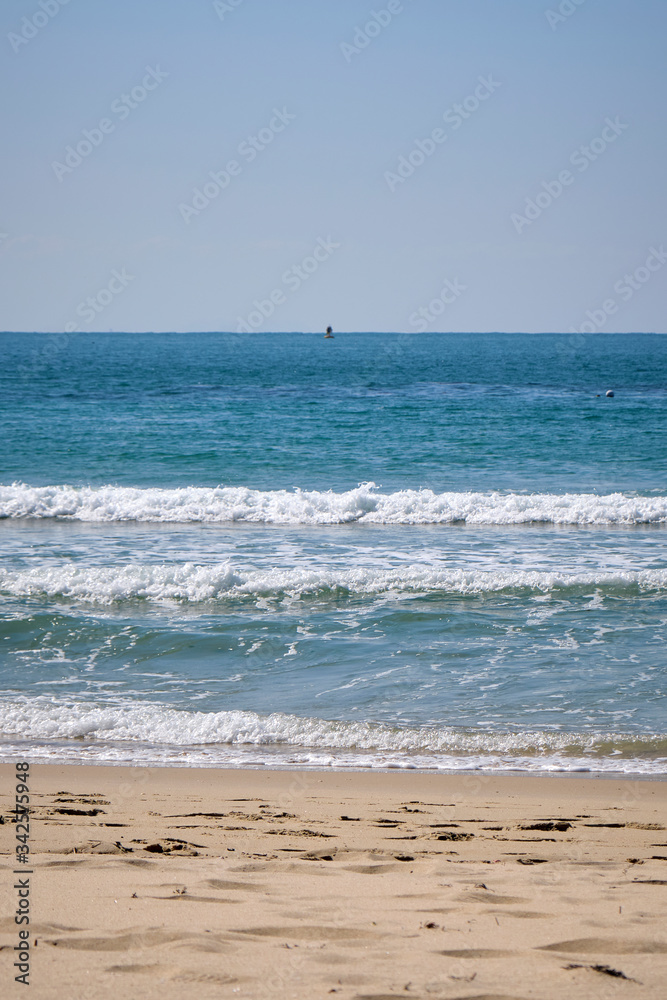 Calm Waves Washing Over a Beach on a Sunny Day