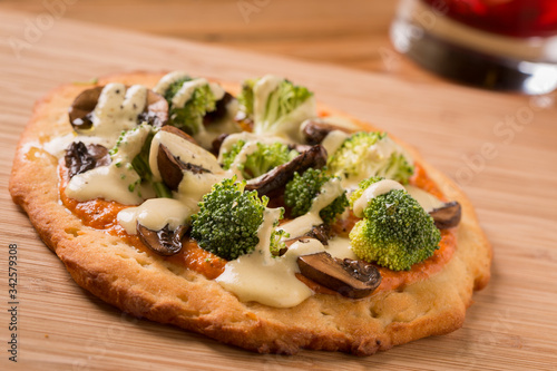 Raw Foods Pizza with broccoli, mushrooms, and cashew cheese