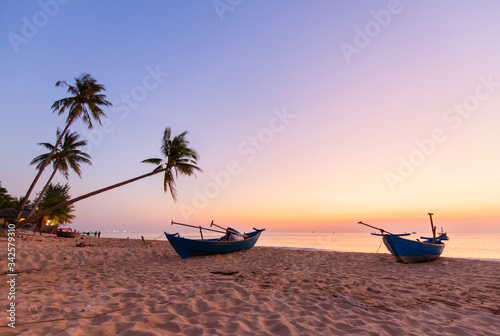DREAM BEACH WITH PALM TREES ON THE WHITE SAND, SUN LOUNGERS, TURQUOISE OCEAN AND BEAUTIFUL CLOUDS IN THE SKY. PHU QUOC ISLAND, VIETNAM
