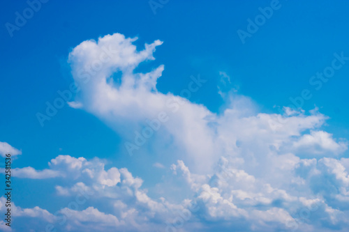 Large white clouds scattered in the blue sky. © Palakorn Jaiman
