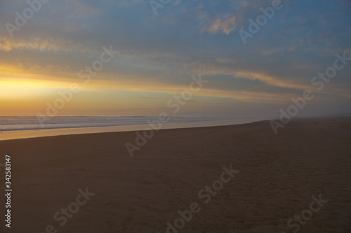 Sunrise view of beach against cloudy sky in Portugal © Bill Gallery
