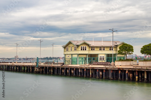 Long exposure of the Princess Pier over a cloudy dramatic at the port of Melbourne. © Ruben