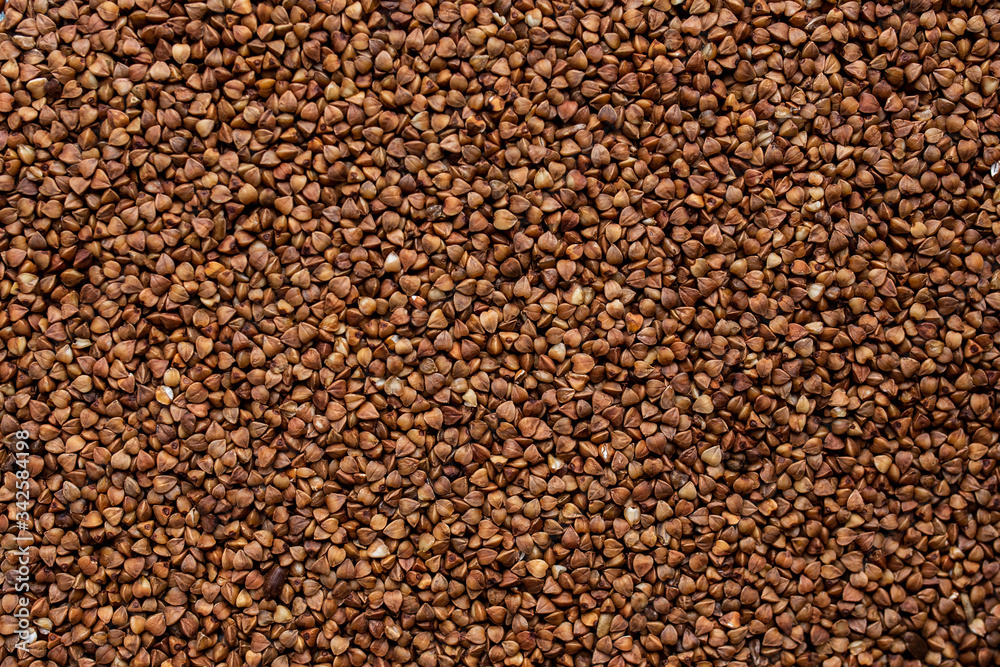 not boiled buckwheat scattered from a close angle not boiled buckwheat scattered from a close angle