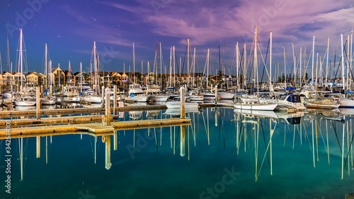 Sailboats moored on a peaceful bay at night, long exposure, Australia. photo