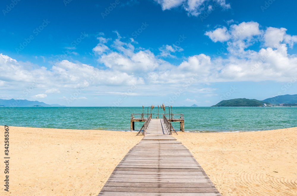 Obraz premium Tropical beach resort with lounge chairs and umbrellas, Nha Trang, Vietnam