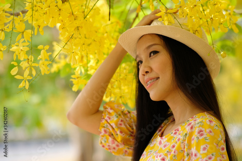 portrait of beautiful woman in yellow dress with summertime