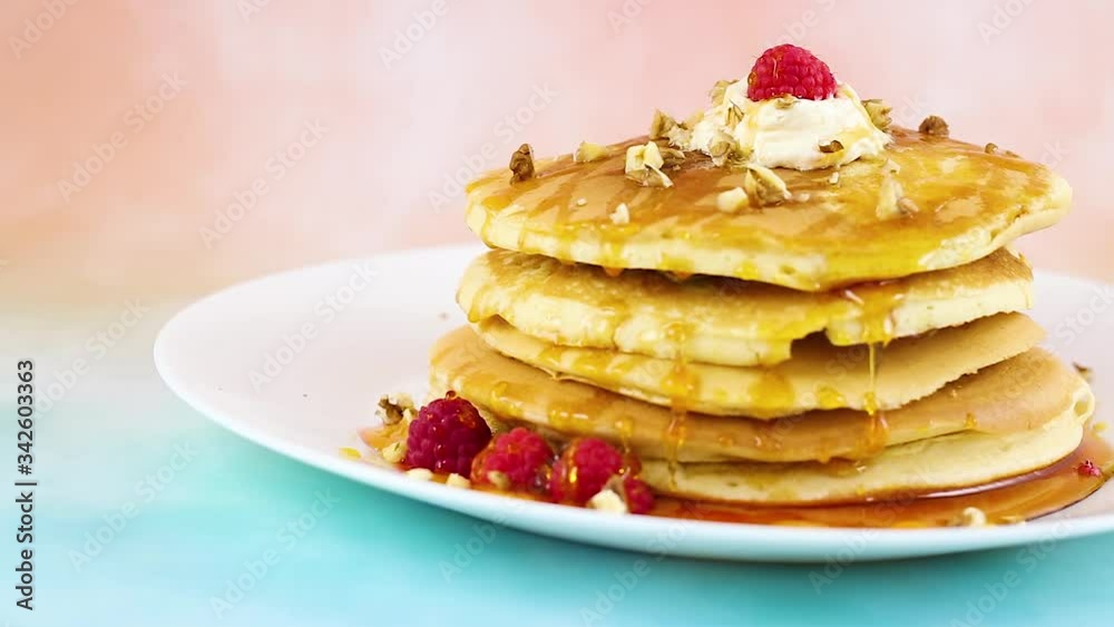 Close up of delicious pancakes with maple syrup and raspberries Close up of delicious pancakes with maple syrup and raspberries