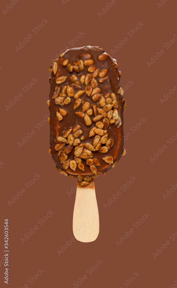 chocolate outer popsicle with melon seeds on brown background