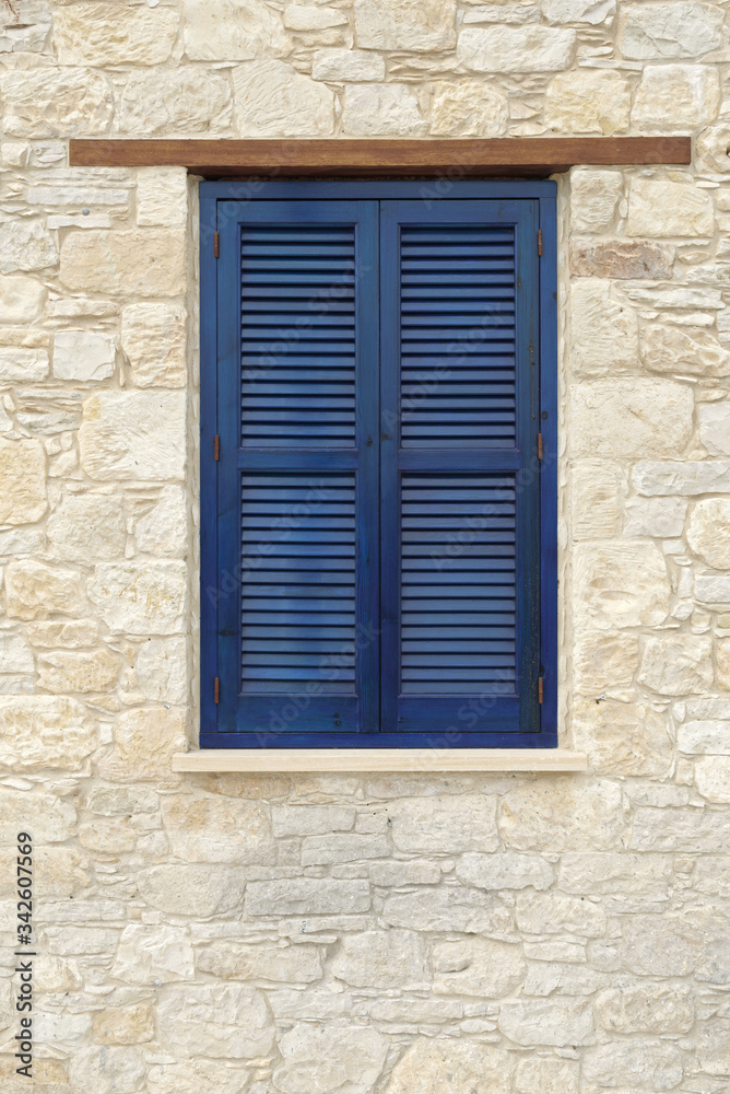 Vintage window with wooden shutters in the village of Omodos. Cyprus