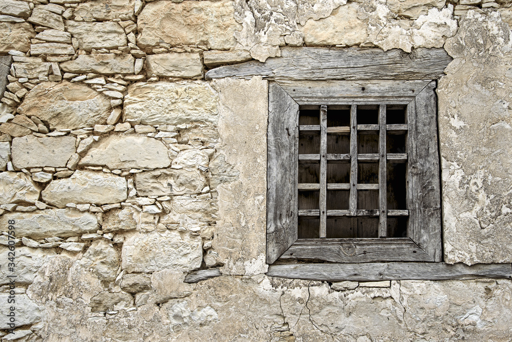 Broken wooden lattice in a window frame in the village of Omodos. Cyprus