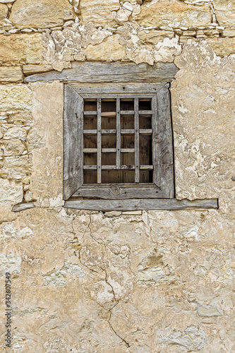 Old boarded up window with a broken wooden frame in the village of Omodos. Cyprus