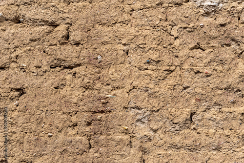 Background of brick wall covered with clay