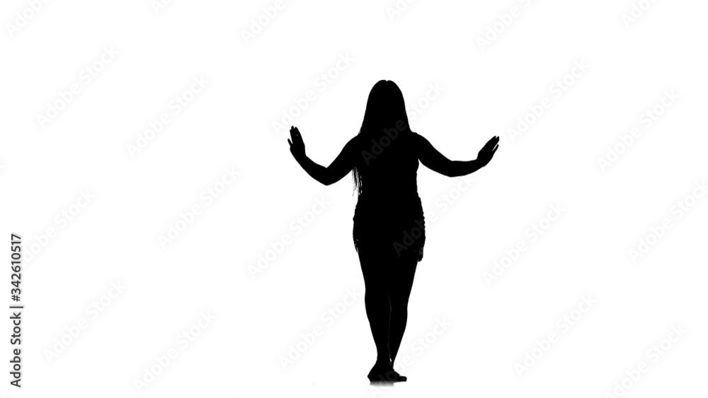 black silhouette on a white background young beautiful woman with long hair and a beautiful figure dances belly dance, oriental dance, exotic dance, slow motion