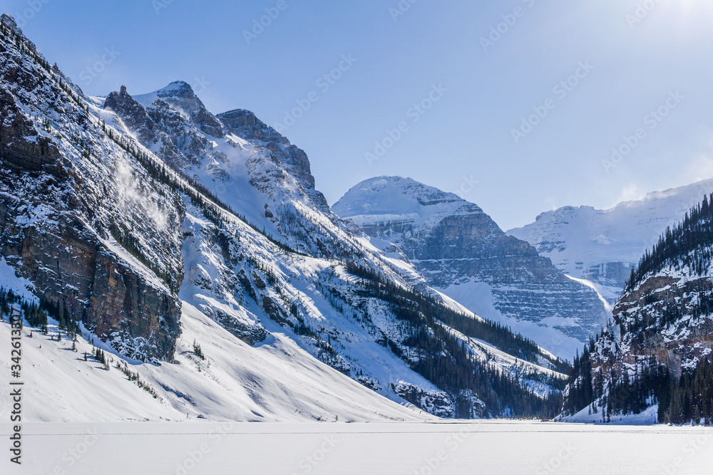 rocky mountains around frozen lake louise winter wonderland.