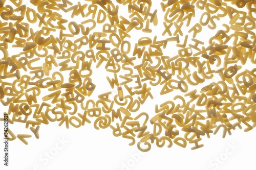 Pasta letters Isolated on a white background.Dry uncooked pasta.Macaroni for kids food.Pasta tiny english letters background.letters pattern