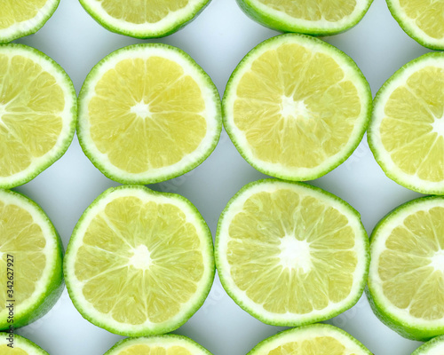 Green background with citrus-fruit of lime slices on white background, Lemon texture
