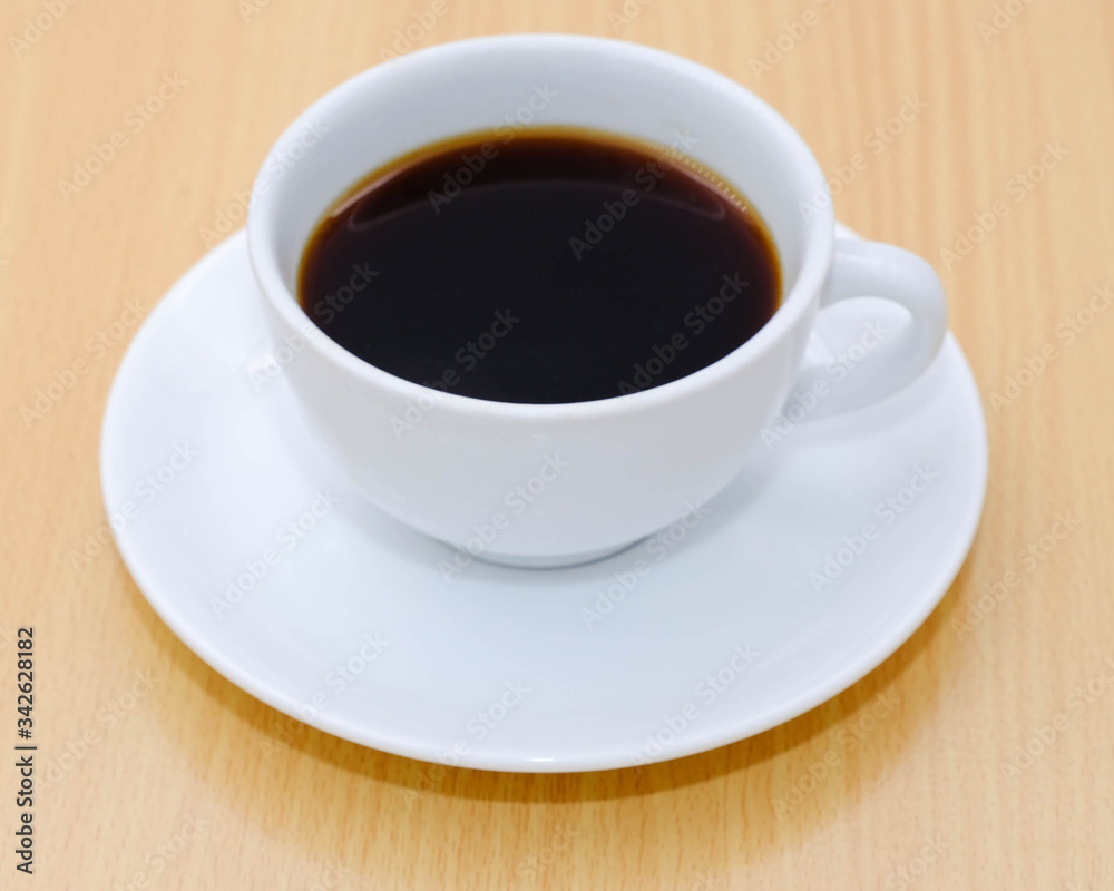 Coffee cup on wooden kitchen table. Top view with morning sunlight Coffee cup on wooden kitchen table. Top view with morning sunlight