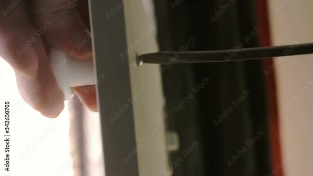 Screwing the plastic handle to the door Cabinet of chipboard Screwing the plastic handle to the door Cabinet of chipboard