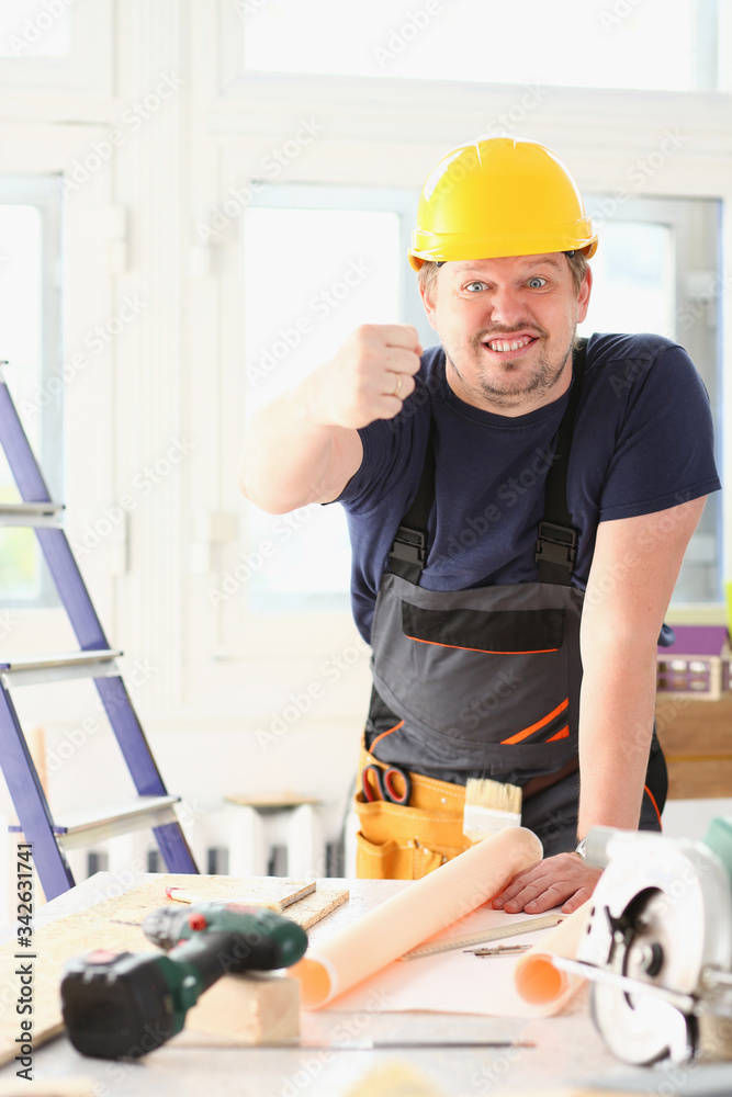 Smiling funny worker in yellow helmet posing. Manual job workplace DIY inspiration improvement fix shop hard hat joinery startup idea industrial energy profession angry concept
