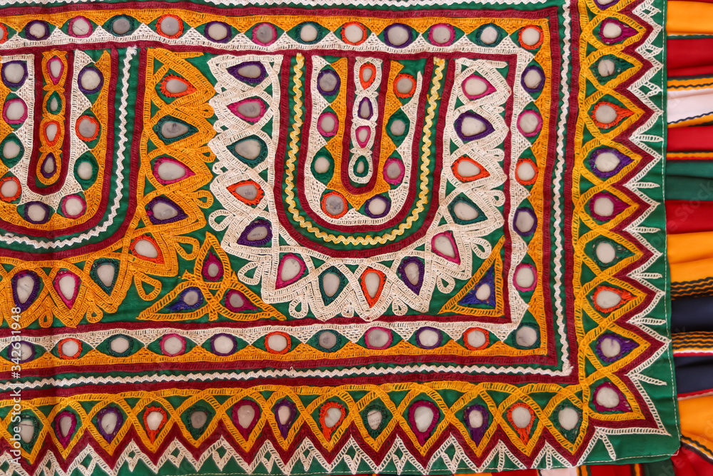 Mirrored embroidery work typical of the Aahir tribe in Gujarat,india,Rajeshthan India embroidery close up view,handwork embroidery,selective focus on handmade embroidery. Traditional Indian handmade e