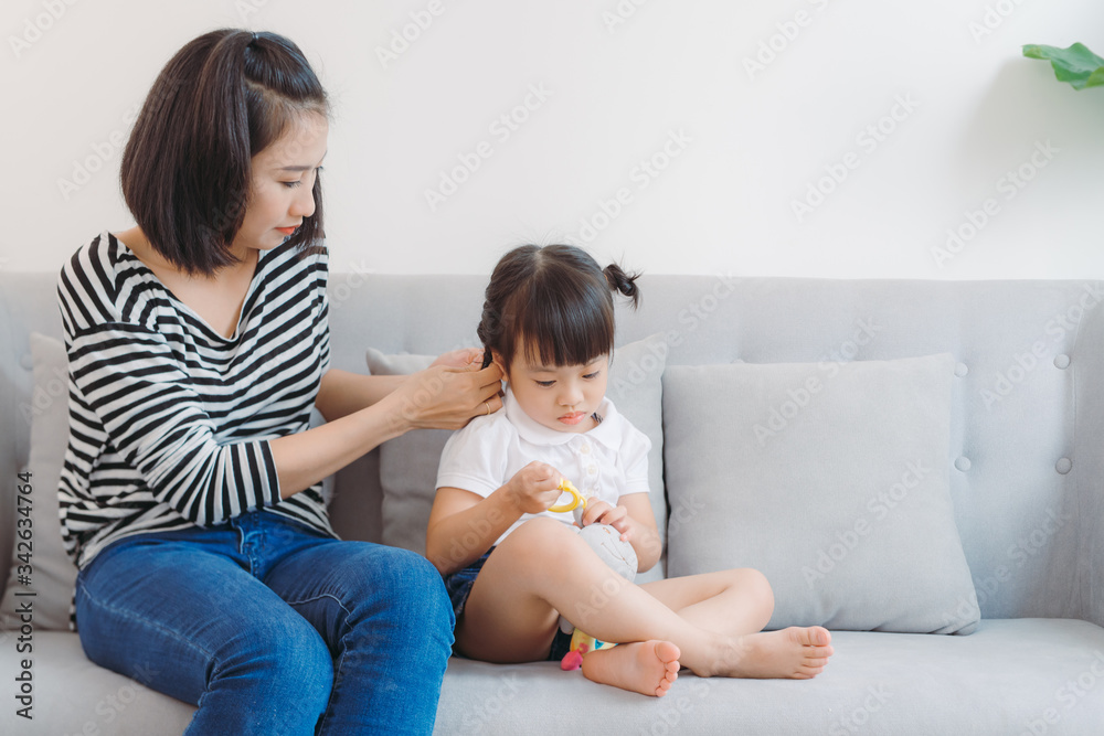Mother combing daughter, care about hairstyle. Mother combing daughter, care about hairstyle.