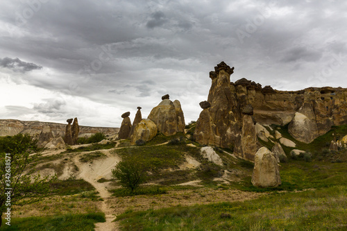 Limestone rock formations under dramatic storm clouds, in Cappadocia, Turkey