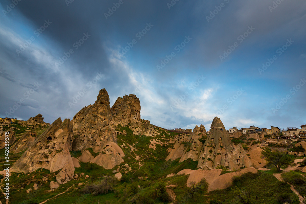 Beautiful sandstone rock formations in Cappadocia, Turkey, under stormy, cloudy, sky