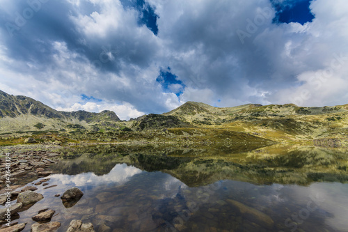 Summer scenery and glacier landscape in the Alps, with beautiful cumulus clouds © Calin Tatu