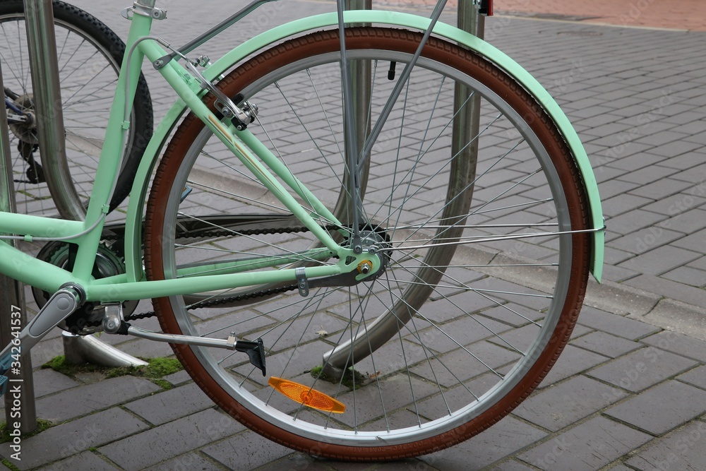 Bicycle on the street. Bicycle rear wheel, kickstand Bicycle on the street. Bicycle rear wheel, kickstand