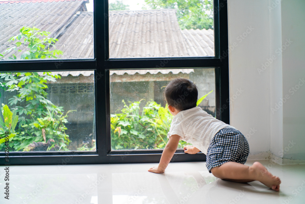 Little asian boy crawling on floor in cozy home Little asian boy crawling on floor in cozy home