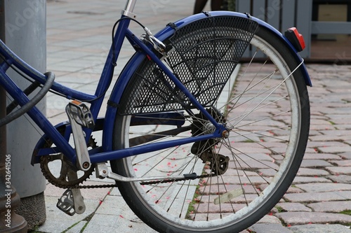 Bicycle on the street, rear wheel,kickstand, protective mesh