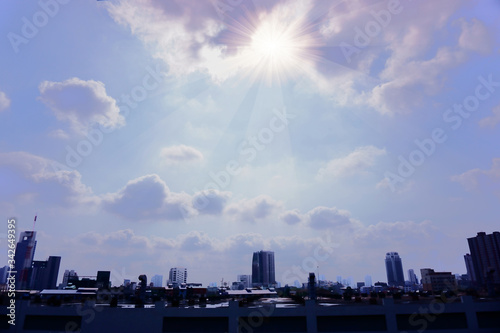 The cloudy sky in sunny day above blurred city, blured photo