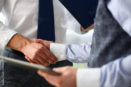 Man in suit and tie give hand as hello in office closeup. Friend welcome mediation offer positive introduction thanks gesture summit participate executive approval motivation male arm strike bargain.