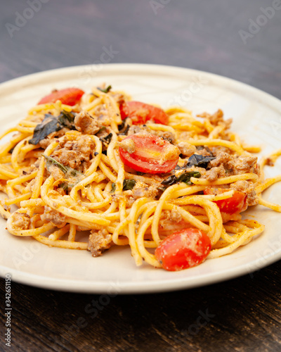 Spaghetti bolognese with tomato, cheese and basil on a plate