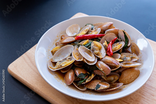 Delicious stir fried clams with chili paste on white plate.Thai food.