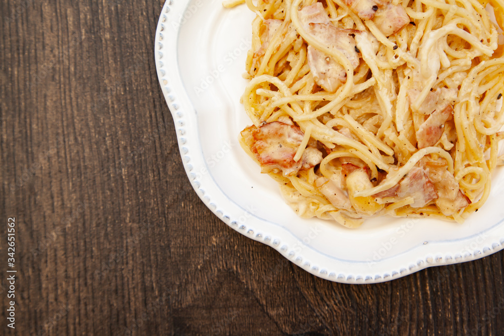 Carbonara pasta, spaghetti with pancetta, egg, hard parmesan cheese and cream sauce. Traditional italian cuisine