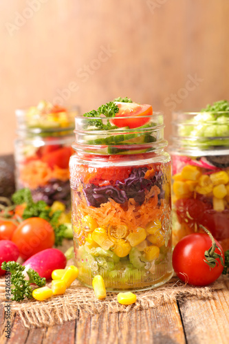 colorful vegetable salad in jar and ingredient