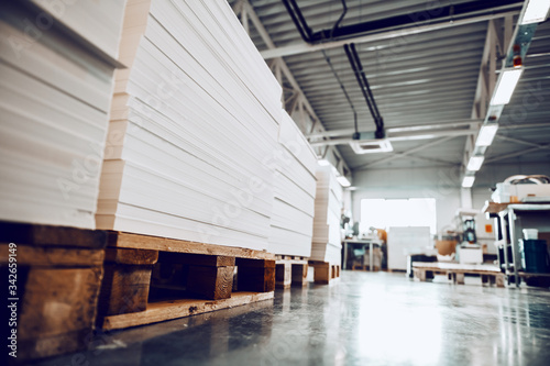 Low angle view of piles of sheets in printing shop.