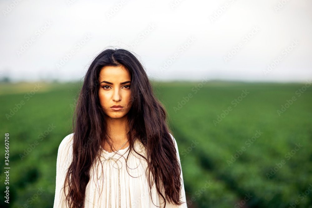 Girl in long dress in the midle of field standing Girl in long dress in the midle of field standing