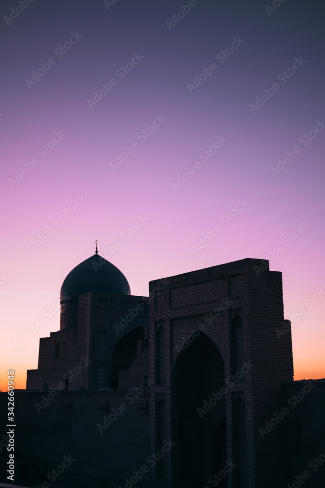 Middle Asia. Uzbekistan Bukhara. Summer. Eastern mosque. Poi Kalyan complex. Mosque on a background of lilac sky