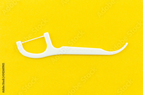 Fototapeta Naklejka Na Ścianę i Meble -  dental floss on yellow background.