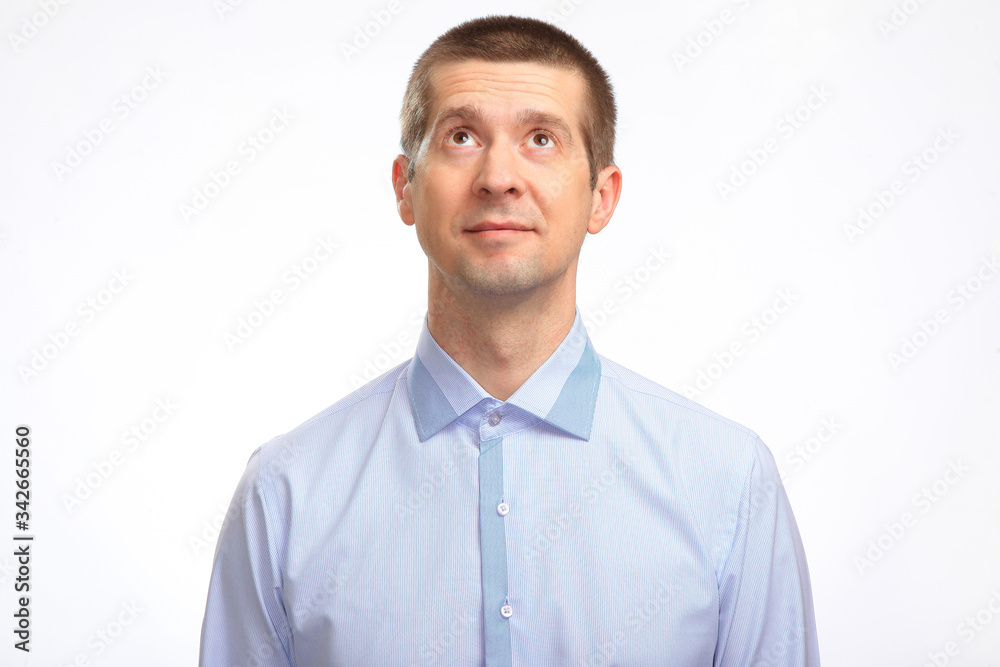 a businessman in a light shirt looks down to the top. Isolated a businessman in a light shirt looks down to the top. Isolated