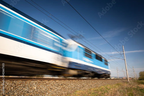 Public transport concept, Blurred train passing through the countryside