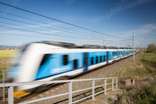 Public transport concept, Blurred train passing through the countryside