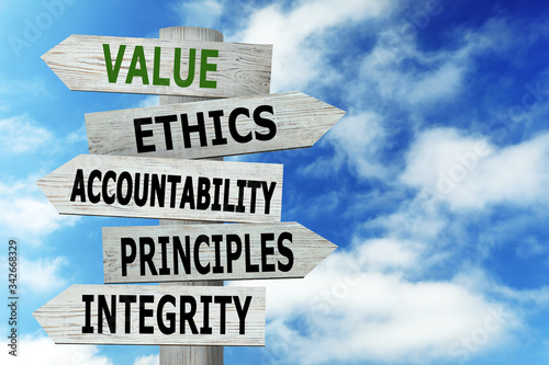 Moral values concept. Wooden signpost with different directions against blue sky photo