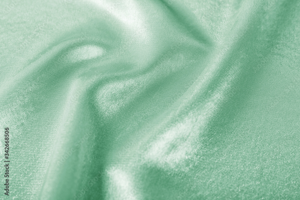 Texture of beautiful silk as background. Image toned in mint color Texture of beautiful silk as background. Image toned in mint color