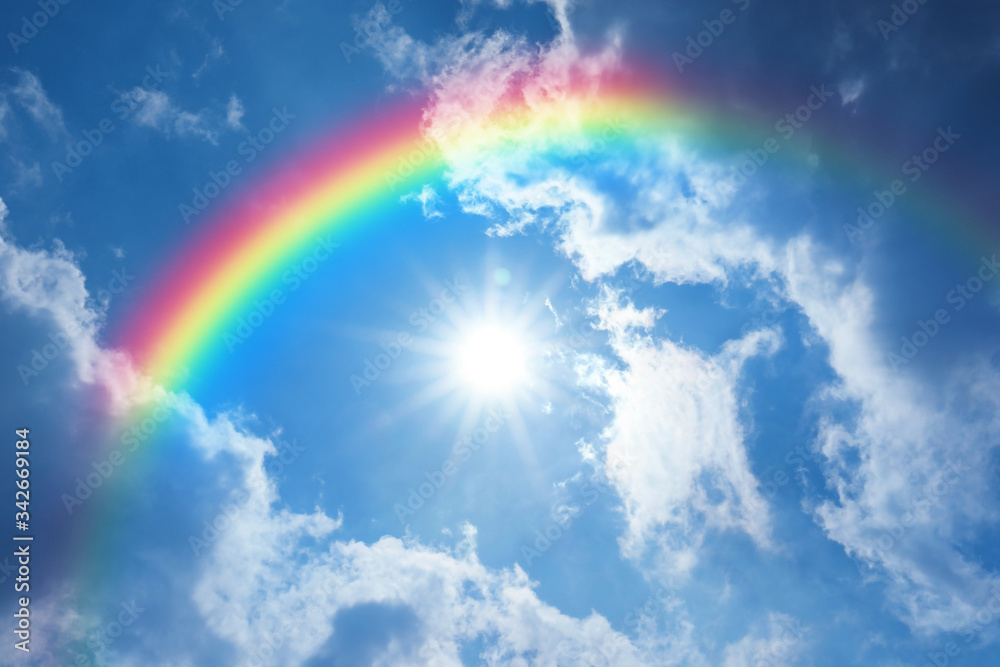 Picturesque view of beautiful rainbow and blue sky on sunny day