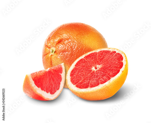 Whole and cut grapefruits on white background