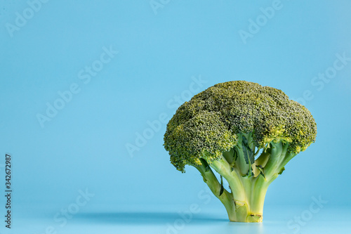 Broccoli on blue background. Piece of broccoli. Top view. Healthy food.